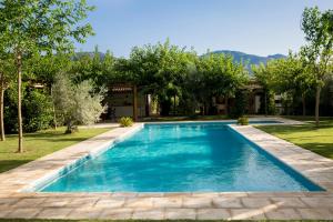 a swimming pool in the yard of a house at Casa Valley Boutique in Melegis