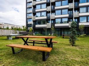 a picnic table in the grass in front of a building at Mycampus 1 bdrm, stay 4, free parking, garden, self check-in in Sofia