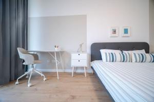 a bedroom with a bed and a desk and a chair at Mycampus 1 bdrm, stay 4, free parking, garden, self check-in in Sofia