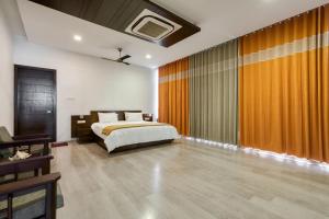 a bedroom with a bed and a large window at Sais lotus villa -Home stay and Event venue in Coimbatore +34 photos
