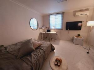 a living room with a couch and a table at Open stay in Goyang +17 photos