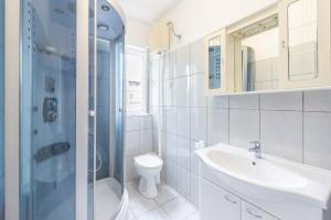 a bathroom with a sink and a toilet and a shower at Apartments Ivan in Novalja +19 photos