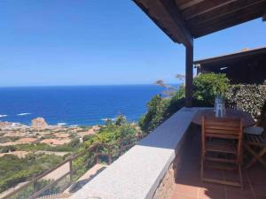 a balcony with a table and a view of the ocean at Villa Mamia Pool Costa Paradiso in Costa Paradiso