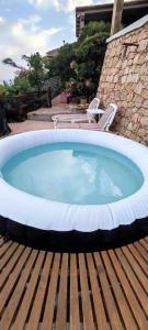 a large plunge pool on a wooden deck with two chairs at Villa Mamia Pool Costa Paradiso in Costa Paradiso +34 photos