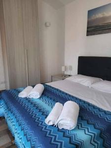 a bedroom with a bed with three pillows on it at Villa Mamia Pool Costa Paradiso in Costa Paradiso