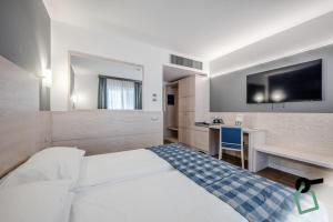 Voodi või voodid majutusasutuse HOTIDAY Room Collection - Torbole toas