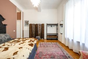 a bedroom with a bed and a large window at Art&Design Boutique Apartment near Ghirlandina in Modena