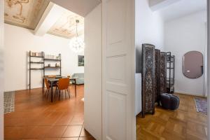 a hallway with a table and a dining room at Art&Design Boutique Apartment near Ghirlandina in Modena +17 photos