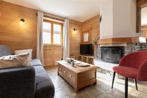 a living room with a couch and a fireplace at Appartement La Mottuaz in Bessans