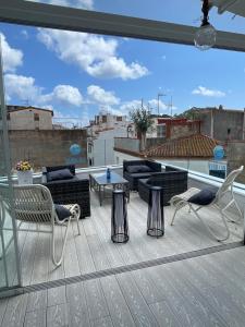 a patio with two chairs and a couch on a roof at Mamma Mia Hotel Boutique - Only Adults in Tossa de Mar