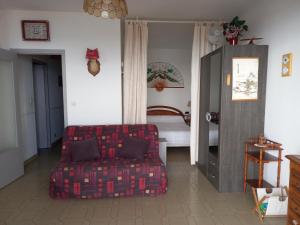 a living room with a couch and a bed at t1 bis vue imprenable in Ajaccio