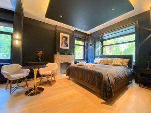 a bedroom with a bed and a table and chairs at ASTRID Mons in Mons