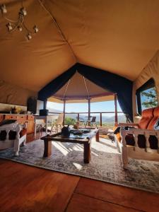 a room with a table and chairs in a tent at Oakron at Patatsfontein Stay in Montagu