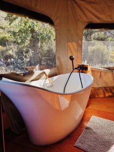 a white bath tub sitting in a tent at Oakron at Patatsfontein Stay in Montagu