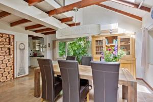a kitchen and dining room with a wooden table and chairs at 't Laankholt in Bornerbroek