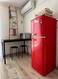 a red refrigerator in a room with a table at Retro room-Otok Vis in Podstražje