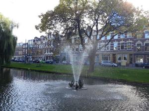 a fountain in the middle of a body of water at The Rotterdam Suite in Rotterdam