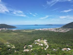 an aerial view of a town and the ocean at Aruna espaco regenerativo in Florianópolis