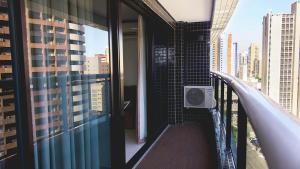 a balcony with a walk in shower in a building at Landscape Comfort Residences in Fortaleza