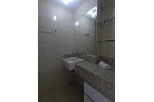 a bathroom with a sink and a mirror at Landscape Comfort Residences in Fortaleza +12 photos