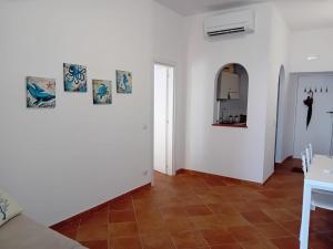 a living room with white walls and a tile floor at About Capri in Anacapri +13 photos