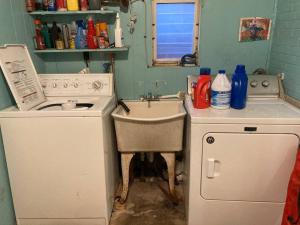 a kitchen with a sink and a washing machine at Black Oak Rest in Philadelphia +11 photos