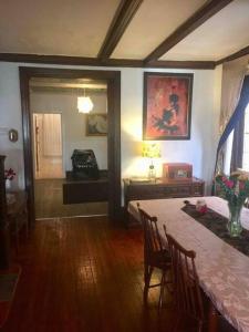 a dining room with a table and chairs and a room with a hallway at Black Oak Rest in Philadelphia