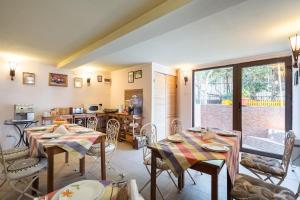 a living room with two tables and a kitchen at Flower's in Bucharest