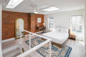 a bedroom with a bed and a staircase with a desk at Modern Marvel at University City in Philadelphia
