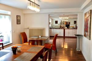 a kitchen and dining room with a table and chairs at Burghotel Lörrach in Lörrach