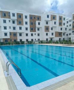 a large swimming pool in front of a building at Comfort Home Two Bedroom in Mombasa