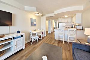 a living room and kitchen with a couch and a table at Daytona Beach Resort Unit #302 in Daytona Beach