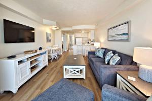 a living room with a couch and a flat screen tv at Daytona Beach Resort Unit #302 in Daytona Beach
