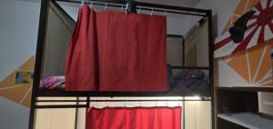 a bedroom with a red curtain and two beds at Beach House Lanzarote in Arrecife