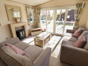 a living room with two couches and a fireplace at The Meadows 45 in Lincoln