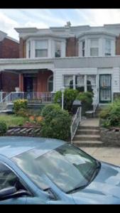 a blue car parked in front of a house at Black Oak Rest in Philadelphia
