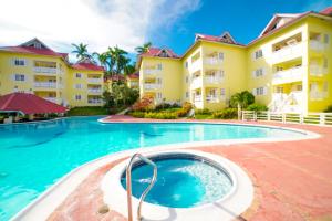 a swimming pool in front of a building at Simply Mystical in Ocho Rios