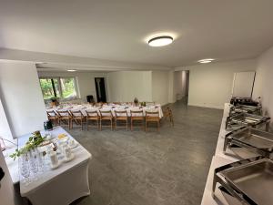 a large room with tables and chairs in it at Apartamenty Chojno-Młyn 46 in Chojno