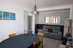 a living room with a table and a couch at Sous La Treille in Saze