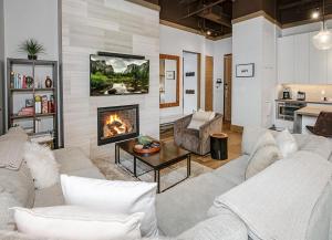 a living room with a couch and a fireplace at Brookside Townhome #107 in Avon