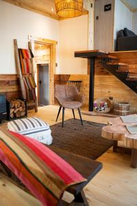 a living room with a couch a chair and a table at Patagonia Mai Casa Boutique in Puerto Natales