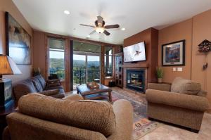a living room with a couch and a fireplace at Peregrine Point 302 in Durango Mountain Resort