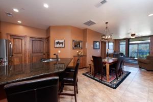 a kitchen and living room with a table and chairs at Peregrine Point 302 in Durango Mountain Resort