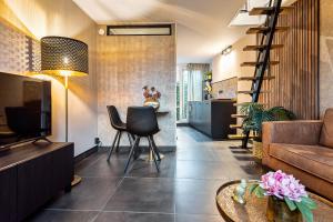 a living room with a couch and a table at Loft 29 in Zandvoort +32 photos