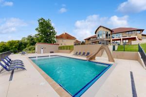 a swimming pool with a slide in front of a house at River View Oasis in Wrightstown