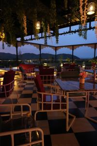 a restaurant with a table and chairs on a checkered floor at Jaipur Qila - A Boutique Hotel and Rooftop Cafe in Jaipur