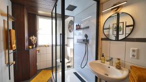 a bathroom with a sink and a mirror at Yellow Lounge Schwarzwald - mit Veranda in Winzeln