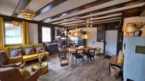 a living room with a couch and a table at Yellow Lounge Schwarzwald - mit Veranda in Winzeln