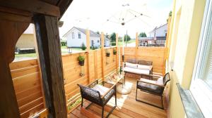 an outdoor patio with chairs and a table at Yellow Lounge Schwarzwald - mit Veranda in Winzeln