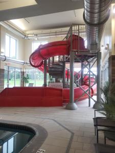 a red slide in a building with a pool at Fairfield Inn & Suites by Marriott in Breinigsville